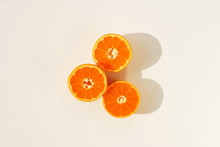 Mandarines, Tangerine, Clementine Slices And Shadows Top View On White Background