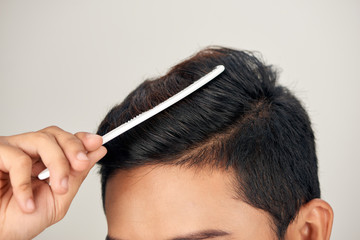 Close up photo of clean healthy man's hair. Young man comb his hair