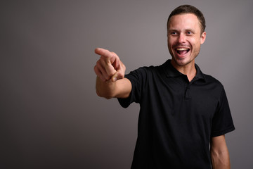 Portrait of handsome man against gray background