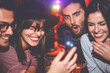 © Alessandro Biascioli - Happy friends having fun watching on mobile smartphone in jazz bar - Group young people using new technology trendy social media apps in club entertainment - Youth millennial and technology concept