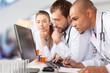 © BillionPhotos.com - Doctors team talking expertise on background