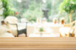 © Phuangphet - Brown empty wooden table top with blurred living room that can see garden background. Light wood with blurry in living room interior.