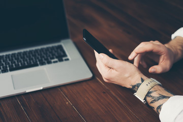 Man pointing on smartphone screen, chatting in social networks, meeting website, searching internet, sending sms, using text messenger or online banking.