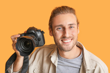 Canvas Print - Young male photographer on color background