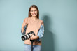 © Pixel-Shot - Beautiful female photographer on color background