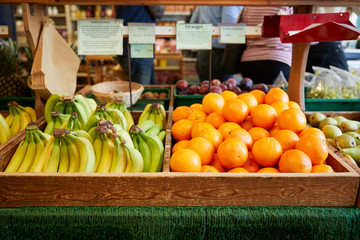 Wall Mural - Display Of Bananas And Oranges In Organic Farm Shop