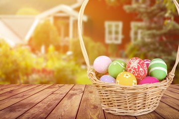 Wall Mural - Easter basket filled with colorful eggs on a white background