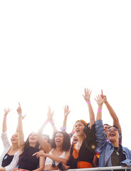 Cheering Young Friends In Audience Behind Barrier At Outdoor Festival Enjoying Music