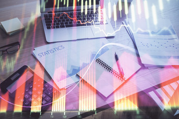 Financial chart drawing and table with computer on background. Multi exposure. Concept of international markets.