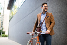 Happy Young Stylish Businessman Going To Work By Bike