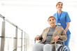 © New Africa - Nurse assisting elderly woman in wheelchair indoors. Space for text