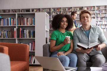 Wall Mural - Group of young people studying in library