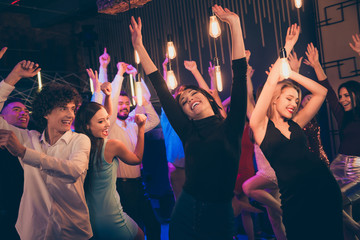 Wall Mural - Photo of cheerful beautiful well dressed students having got access to night club and enjoying their free time celebrating fest