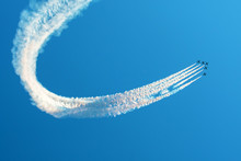 Fighter Jets Flying Against A Bright Sky, Performing Figures Turns From The Smoke.