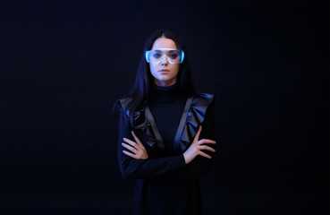 Wall Mural - beautiful woman in glasses of virtual reality on dark background. augmented reality, future technolo