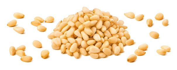 Wall Mural - pine nuts pile and separate kernels isolated on white background