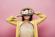 © LIGHTFIELD STUDIOS - asian woman holding wooden cubes in front of face with fake and fact lettering isolated on pink