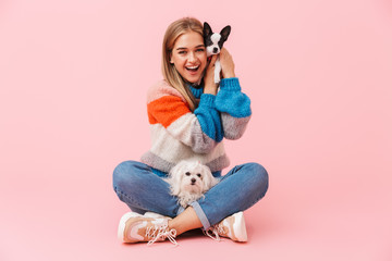 Cute lovely girl wearing sweater sitting with legs crossed