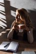 © LIGHTFIELD STUDIOS - attractive and blonde businesswoman holding cup and looking away in office