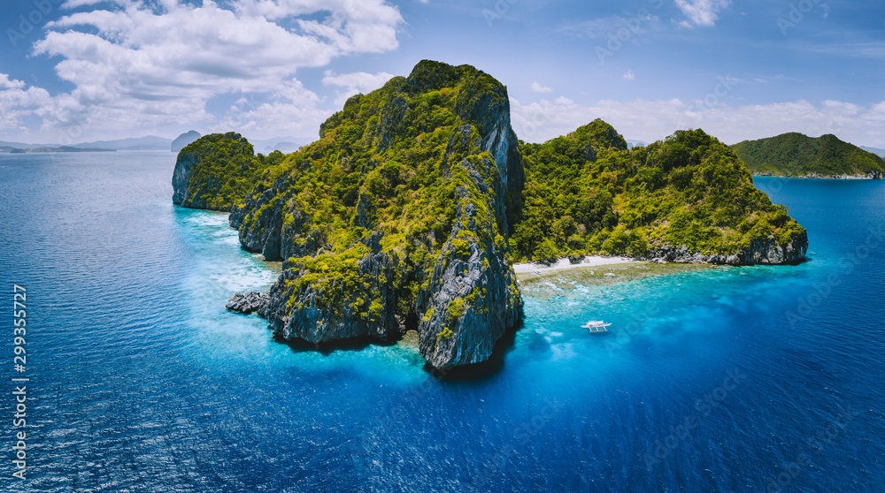 Aerial drone panorama view of tropical paradise island. Karst limestone rocky mountains surrounds by blue ocean and coral reef - obrazy, fototapety, plakaty 