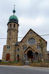 Wall Mural - Church of the Immaculate Conception in Medell, Belgium exterior facade street view under overcast April sky