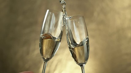 Wall Mural - Super slow motion of having a toast with two champagne glasses with speed ramping effect. Filmed on high speed cinema camera, 1000fps