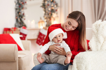 Sticker - Happy mother with cute baby in room decorated for Christmas holiday