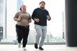 © New Africa - Overweight couple running together outdoors. Fitness lifestyle