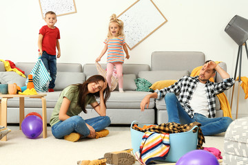Wall Mural - Frustrated parents and their mischievous children in messy room