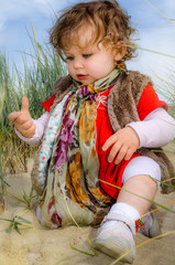 Canvas Print - pretty little girl on vacation playing in the sand