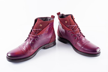 Pair of male red leather boots on white background, isolated product, top view.