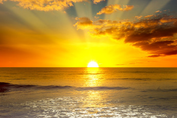 Wall Mural - majestic bright sunrise over ocean and light waves