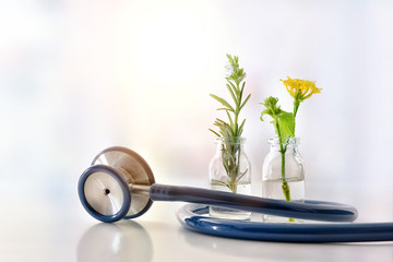 vials with plants inside and stethoscope natural medicine concept