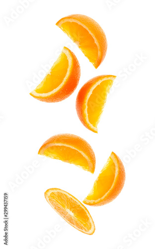 Fotomural falling fresh orange fruit slices isolated on white background closeup