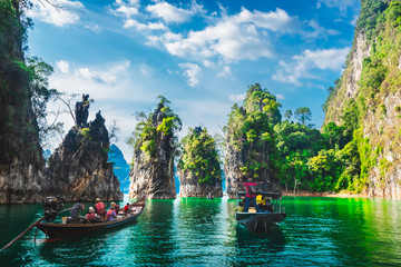 Group of adventure travelers on boat joy beautiful nature scenic landscape Khao Sok national park, Amazing landmark travel Thailand, Tourist people on holiday vacation trips, Tourism destination Asia