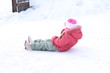 © epovdima - Child rides from a hill on an ice in winter. Girl child rolls downhill. Winter fun games
