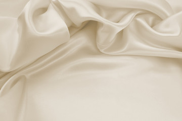 Wall Mural - Delicate satin draped fabric beige texture for festive backgrounds