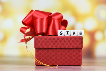 Wall Mural - Give gift concept - Giving a gift box present wrapped with red ribbon for Christmas time holiday or valentines day