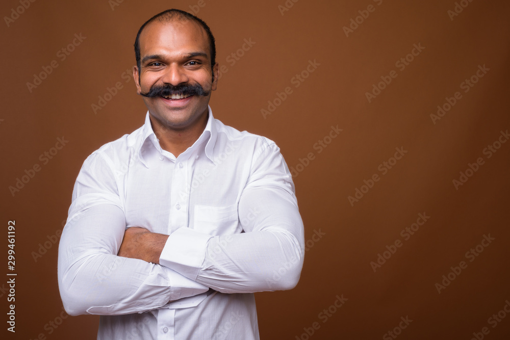 Portrait of happy Indian businessman with mustache in casual clothing - obrazy, fototapety, plakaty 