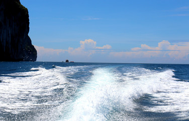 boat ride on the sea, exotic James Bond islands against the blue sea, waves of spray in Thailand