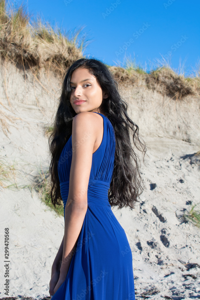 Beautiful model looking at camera at the beach in Sligo in Ireland. Mixed  race Portuguese Indian female model posing. Blue dress. Black hair model.  Irish coastline. Stock-foto | Adobe Stock