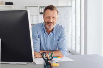 Attentive serious businessman staring at camera
