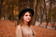 © Yaroslav - Autumn girl in the park. Sweater, hat and leather skirt. Stylish image. Atmosphere. Makeup