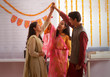 © IndiaPix - Employees standing together in office holding hands during Diwali celebrations.