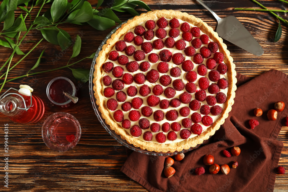 Tasty raspberry pie on wooden table
