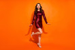 © deagreez - Full length body size view of her she nice attractive smart pretty feminine gorgeous cheerful cheery wavy-haired girl posing having fun isolated over bright vivid shine vibrant orange color background