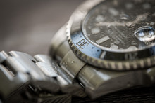Close-up, Shallow Focus Of A Luxury, Swiss Manufactured Men's Mechanical Diving Watch Showing Droplets Of Water On The Face And Strap.