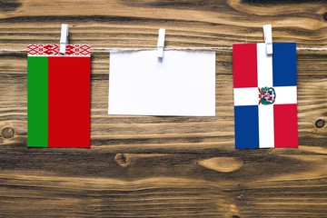 hanging flags of belarus and dominican republic attached to rope with clothes pins with copy space o