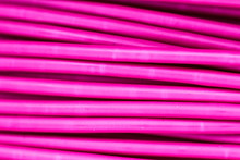 Pink Wire, The Coil Of Plastic In The Macro. Close-up Of A Strip Of Plastic In A Reel Of Turquoise Color. 