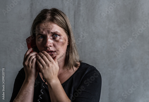 Scared  woman victim of domestic violence and abuse asks for help by phone. Empty space for text